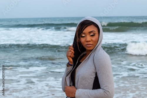 Lady in a hoodie by the beach