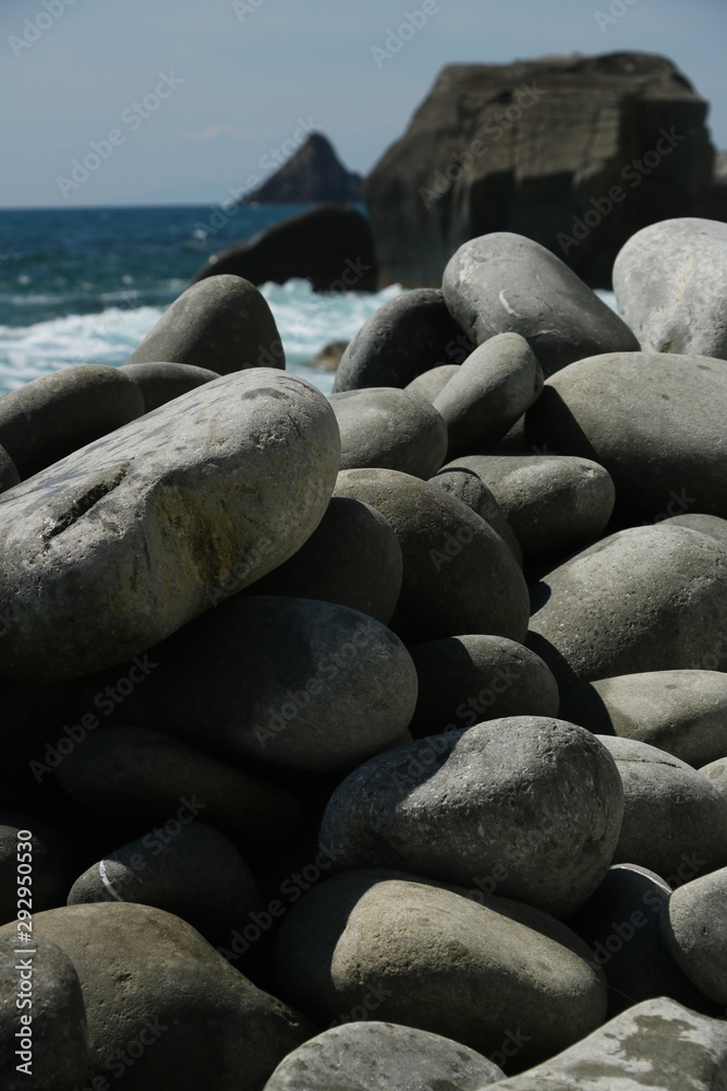 Beach with large stones near the Cinque Terre. Velvety sea with long exposure. Scoglio del Ferale, La Spezia.