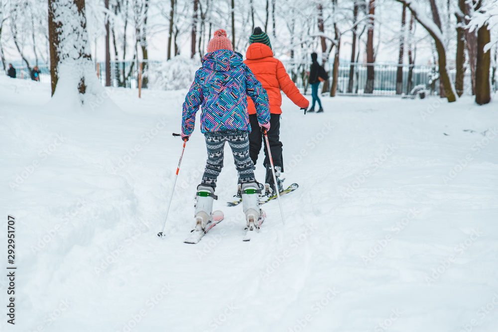 kids skiing in snowed city park kids skiing in snowed city park