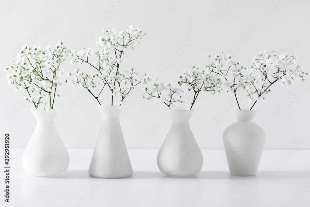 Obraz premium Home interior floral decor. Elegant floral soft white composition. Beautiful white gypsophila flower in vase on white wall background.