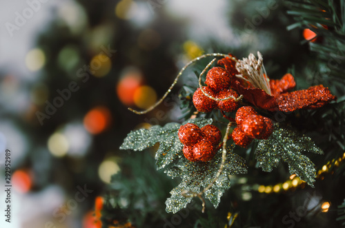Merry Christmas. close up red color decorated ball hanging on christmas tree with bokeh light background, holiday family, happy new year and merry christmas festival concept, vintage color tone effect