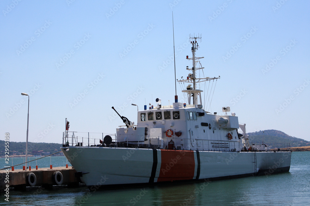 A coast guard boat tied to pier.