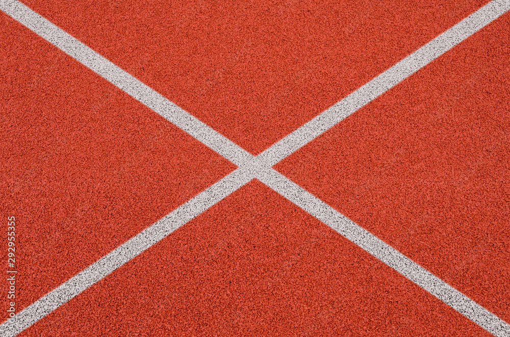 Top view of the running track rubber lanes cover texture with white line marking for background. Top view of the running track rubber lanes cover texture with white line marking for background.