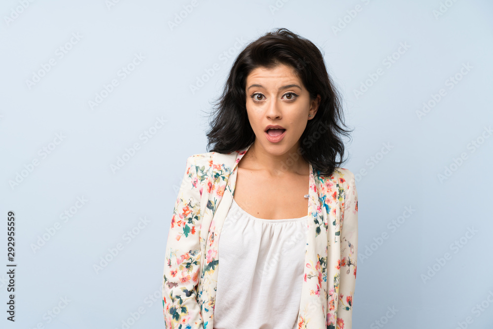 Young woman over isolated blue background with surprise facial expression Young woman over isolated blue background with surprise facial expression