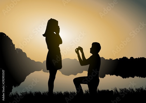 Wedding proposal concept. Young couple have dating at sun set. Man in love is kneeling on knees and giving wedding ring to surprised woman.
