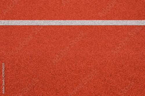 Top view of the running track rubber lanes cover texture with white line marking for background. © tkroot
