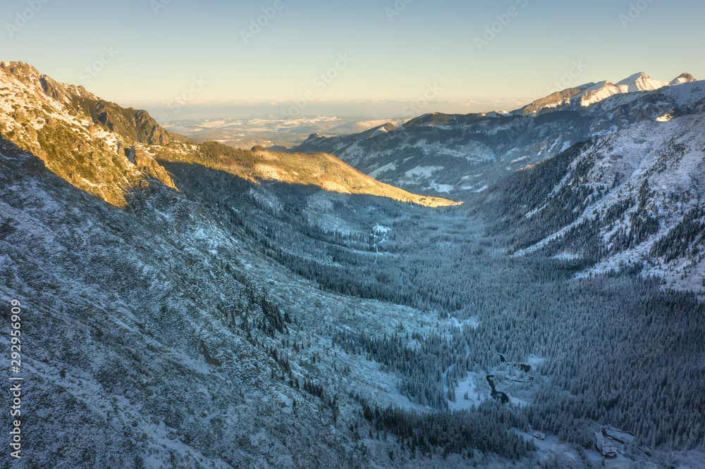 Winter mountains. Aerial view of snowy mountain valley. Tatra mountains from above, Poland Winter mountains. Aerial view of snowy mountain valley. Tatra mountains from above, Poland
