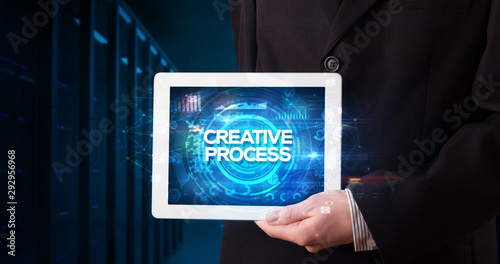 Wallpaper Mural Young business person working on tablet and shows the inscription: CREATIVE PROCESS, business concept Torontodigital.ca
