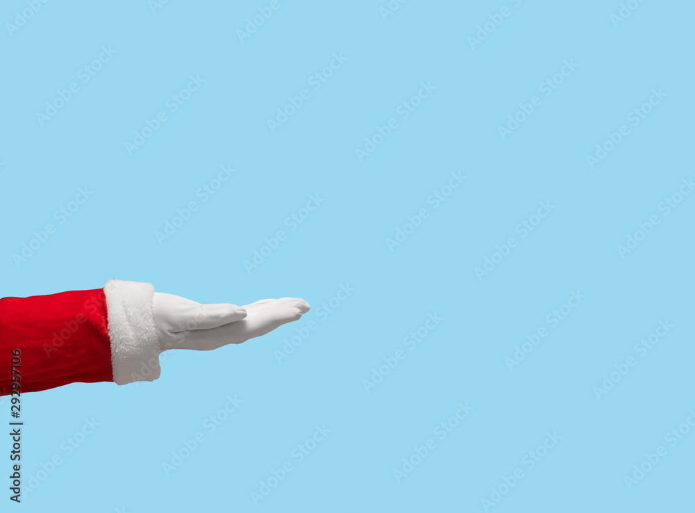 Santa Claus hand on blue isolated background.