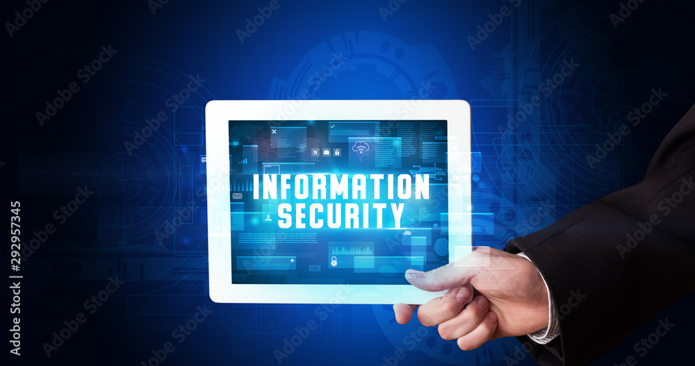 Young business person working on tablet and shows the digital sign: INFORMATION SECURITY Young business person working on tablet and shows the digital sign: INFORMATION SECURITY