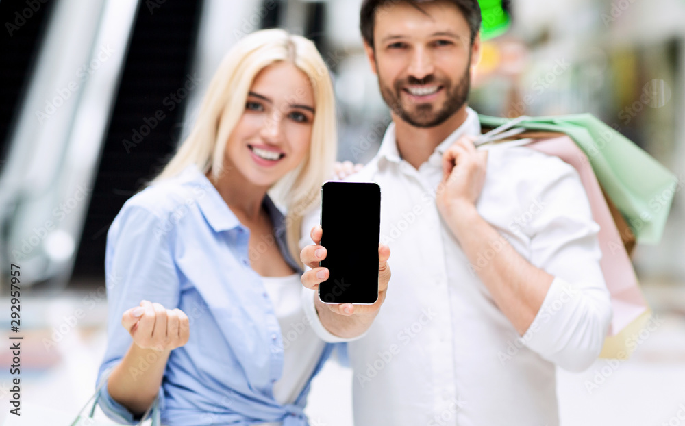 Spouses Showing Empty Mobile Phone Screen Standing In Mall, Mockup Spouses Showing Empty Mobile Phone Screen Standing In Mall, Mockup