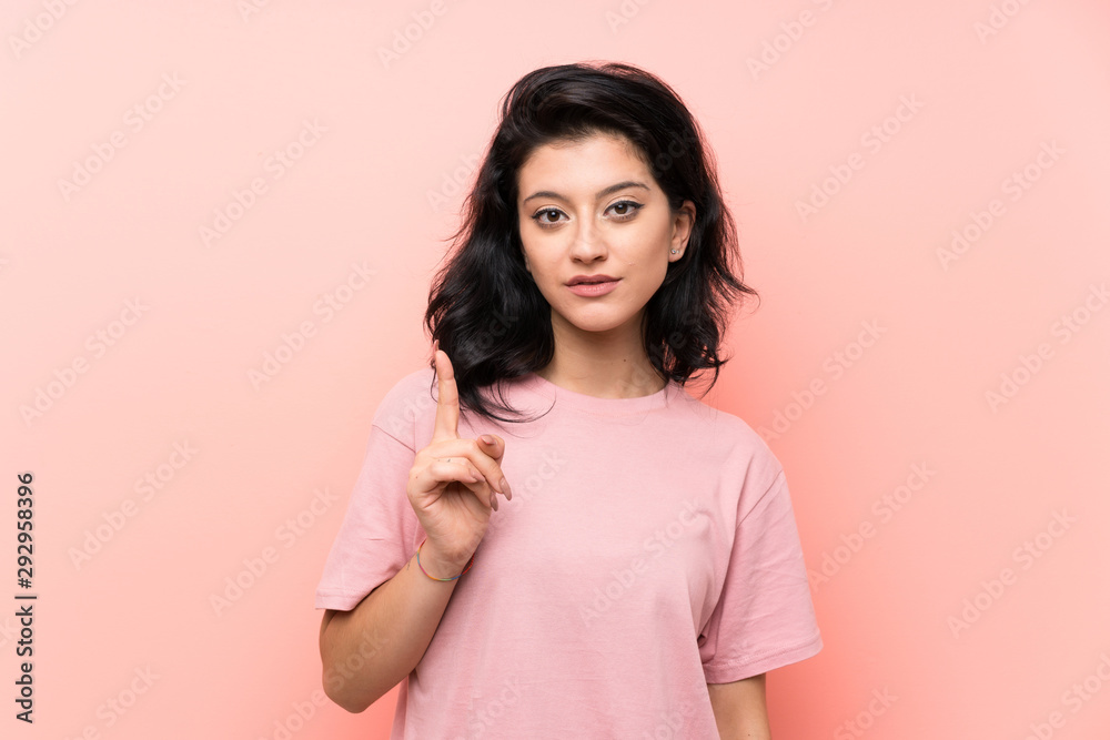 Young woman over isolated pink background pointing with the index finger a great idea Young woman over isolated pink background pointing with the index finger a great idea