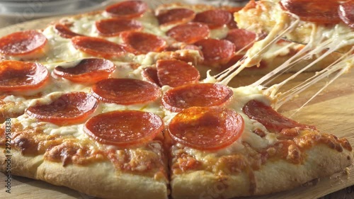 A slice of pepperoni pizza being served.