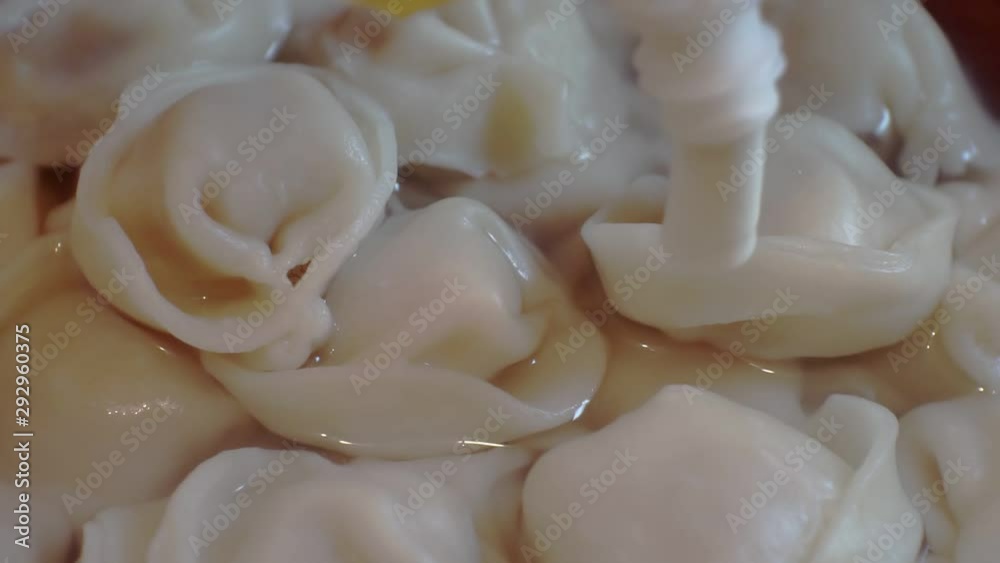 home-cooked Russian dumplings on which sauce is poured on top.close-up home-cooked Russian dumplings on which sauce is poured on top.close-up