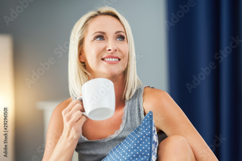 Schilderij op canvas Adult beautiful woman waking up fully restedand drinking coffee