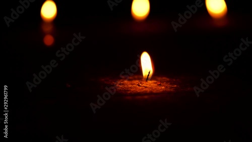 Burning candle just on the verge of being finished footage with copy space isolated on black dark background. Concept for Diwali, religious decoration,culture,grief,protest,death.