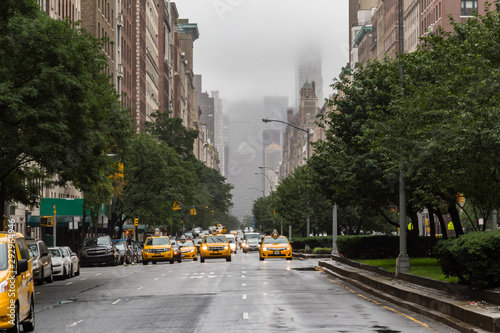 Fotografie, Obraz Head on view of multiple yellow cabs or taxicabs on Park Avenue in Upper East Si