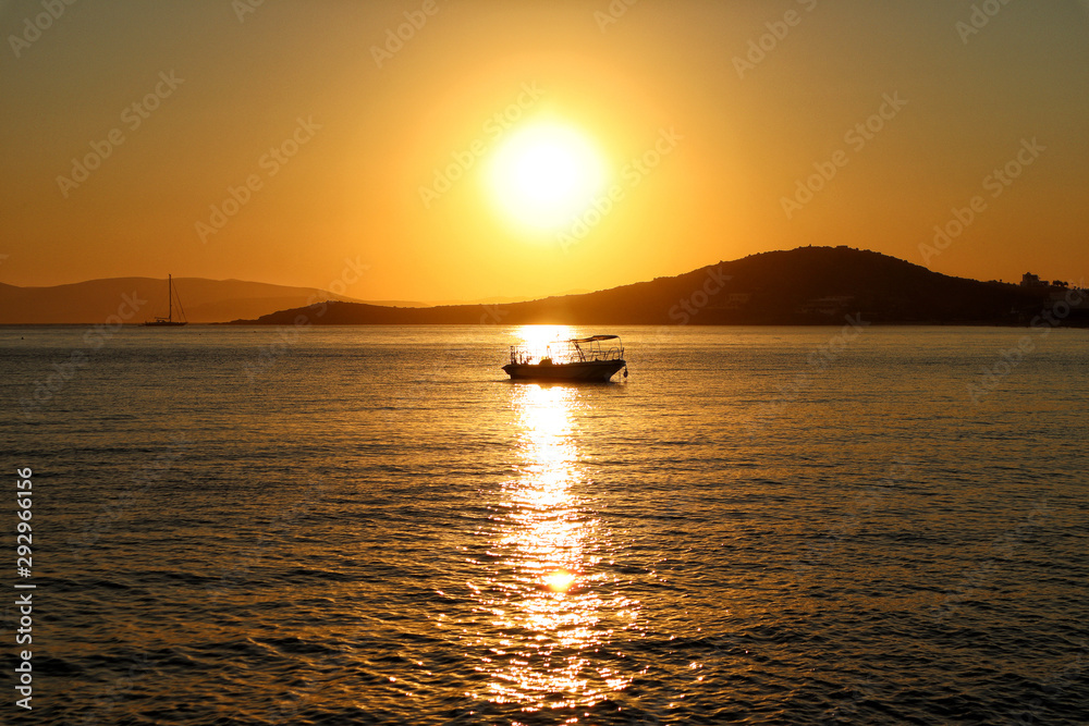 Silhouette of a small boat at sunset, Naxos Greek Islands