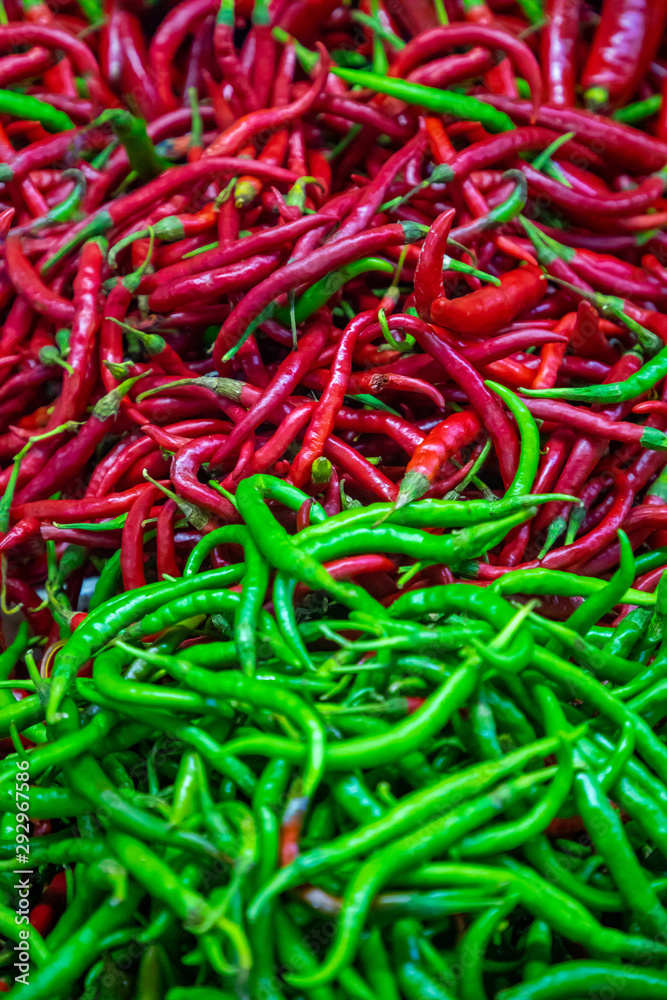 Green and red chili peppers background