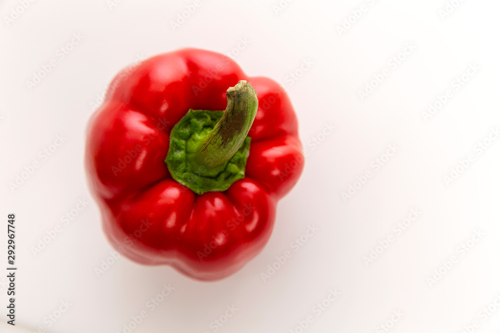 Juicy red bell pepper on a white background. Diet vegetarian food. Top view. Juicy red bell pepper on a white background. Diet vegetarian food. Top view.