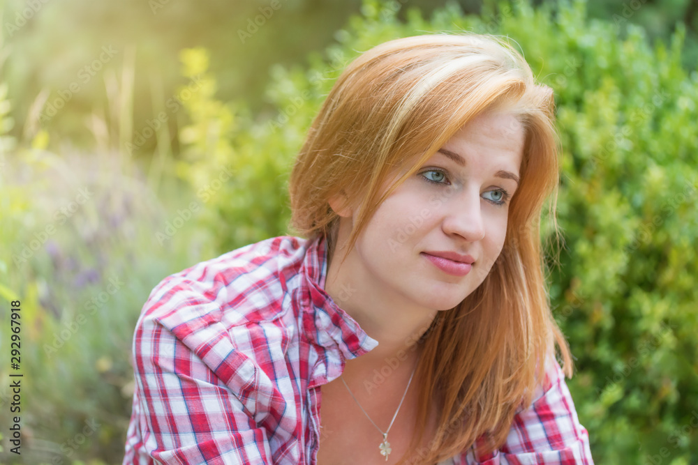 Portrait of young woman with a saddened smile