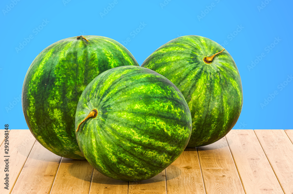 Watermelons 3d rendering with realistic texture on the wooden table Watermelons 3d rendering with realistic texture on the wooden table