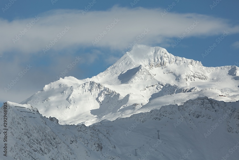 Snowy mountains in winter weather with ski slopes