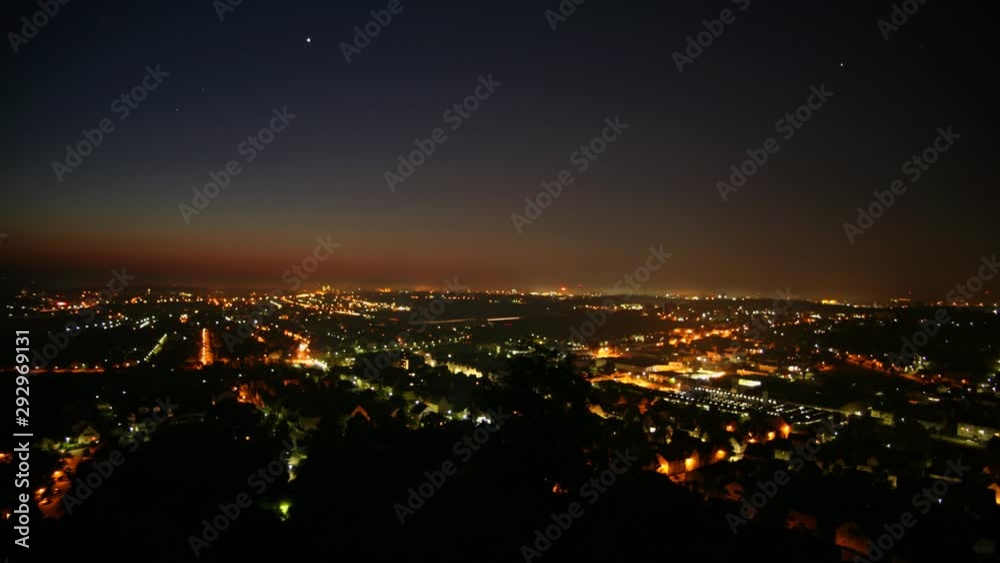 Time lapse overlooking a city. Lights change as the city goes from night to early morning. Time lapse overlooking a city. Lights change as the city goes from night to early morning.