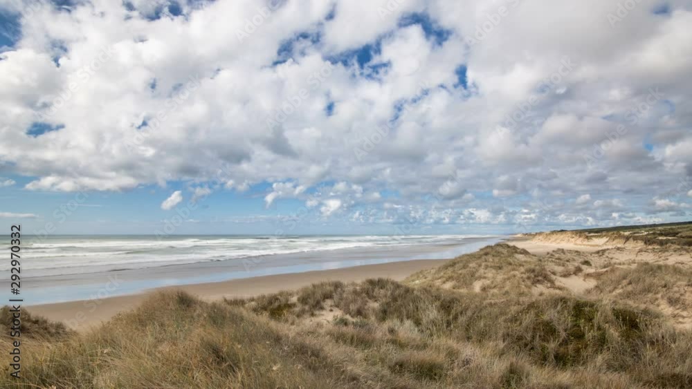 Clouds moving over ocean beach grassy coastline in New Zealand wild nature Clouds moving over ocean beach grassy coastline in New Zealand wild nature