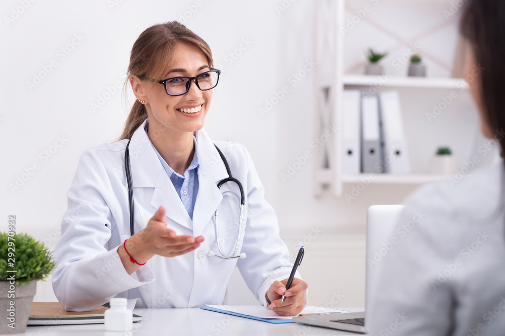 Lady Doctor Talking With Unrecognizable Patient During Appointment In Office Lady Doctor Talking With Unrecognizable Patient During Appointment In Office