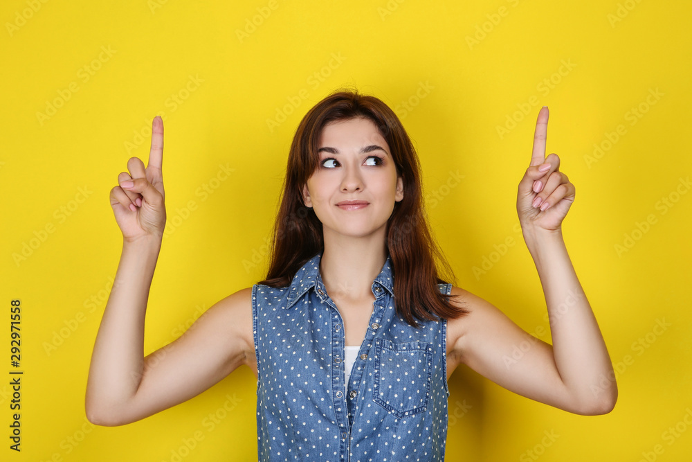 Young woman in stylish clothing on yellow background Young woman in stylish clothing on yellow background