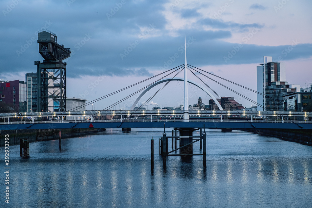 City landscape with two bridges in the evening. The Clyde Arc and Bells Bridge, Glasgow, United Kingdom City landscape with two bridges in the evening. The Clyde Arc and Bells Bridge, Glasgow, United Kingdom