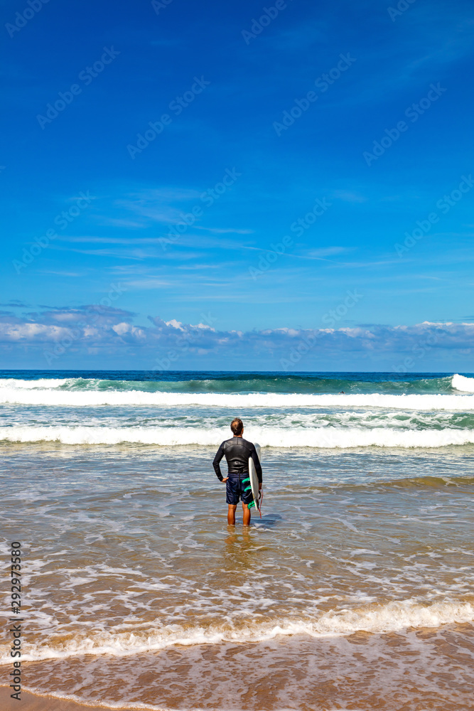 San Sebastian, Spain - View of a surfer watching the waves