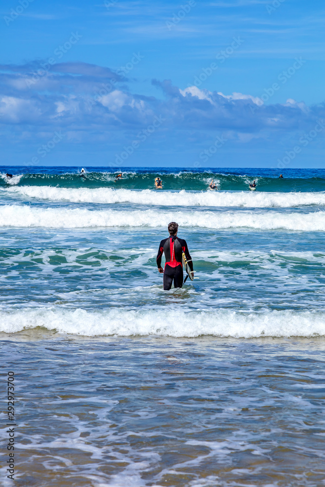 San Sebastian, Spain - View of a surfer watching the waves San Sebastian, Spain - View of a surfer watching the waves