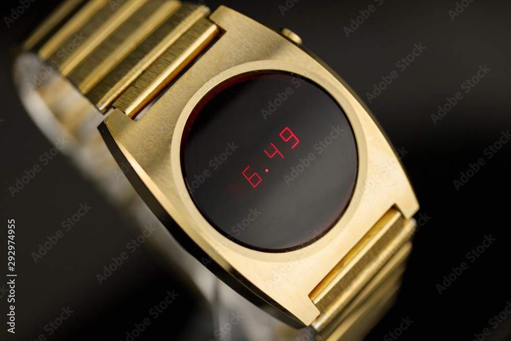 LED gold digital watch vintage retro wristwatch with red display 70s 80s  isolated alarm multifunctional chronograph scratched steel used made in usa  rare worn watch Armbanduhr golden luxurious side Stock Photo