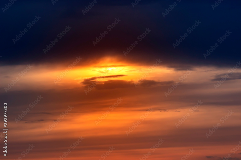 Fiery orange sunset sky. Beautiful sky with clouds.