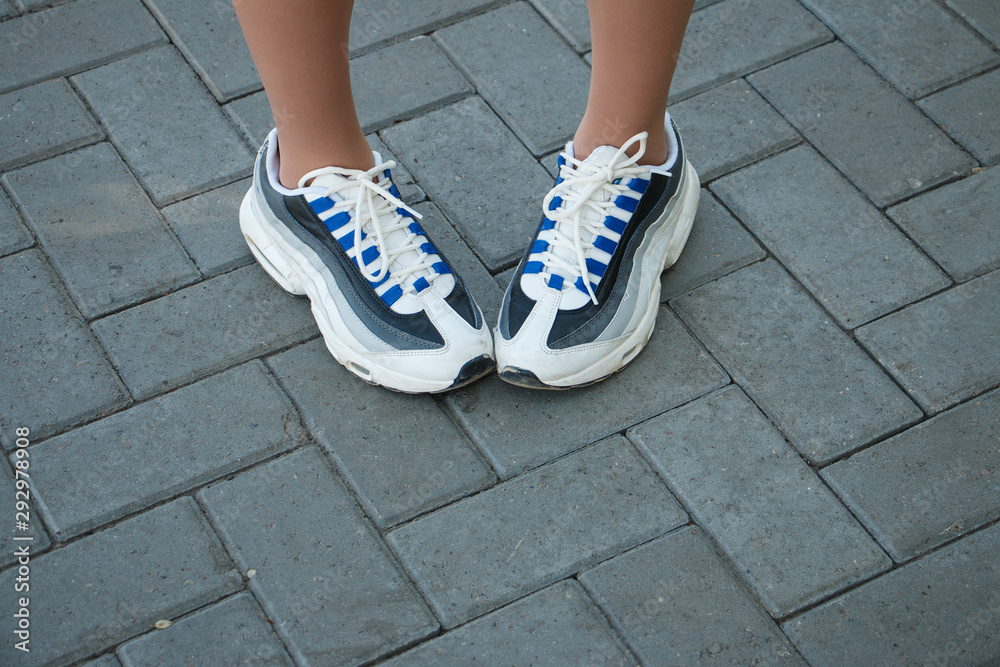 girl's feet in sports shoes