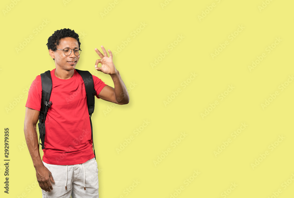 Happy young man doing an all right gesture Happy young man doing an all right gesture