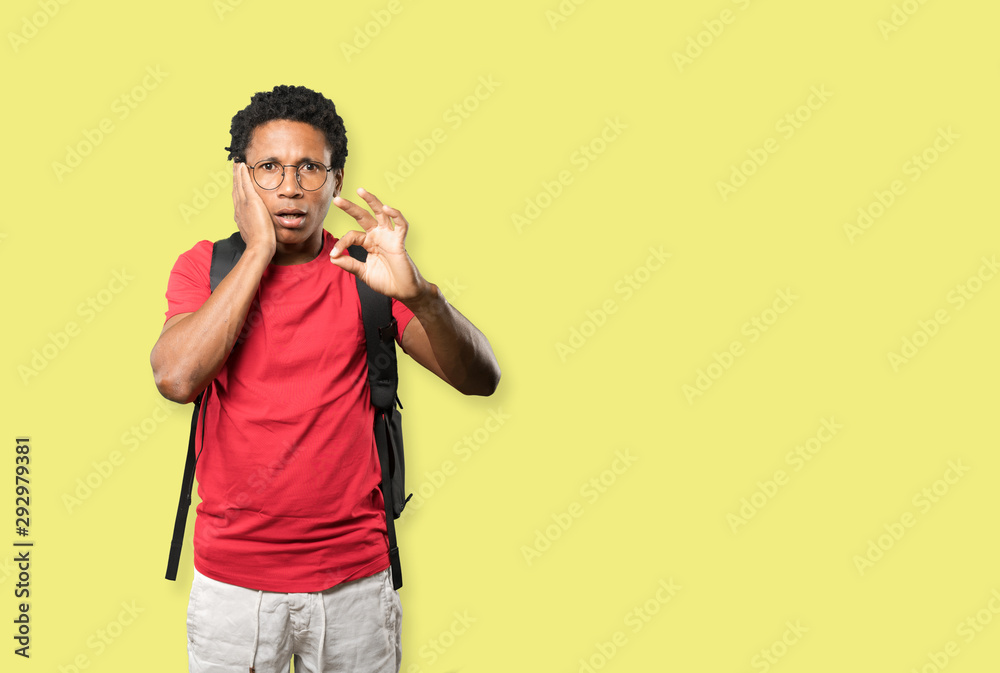 Surprised young man with a gesture of approval Surprised young man with a gesture of approval
