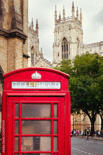 Old british red phone booth with the York Cathedral on the background