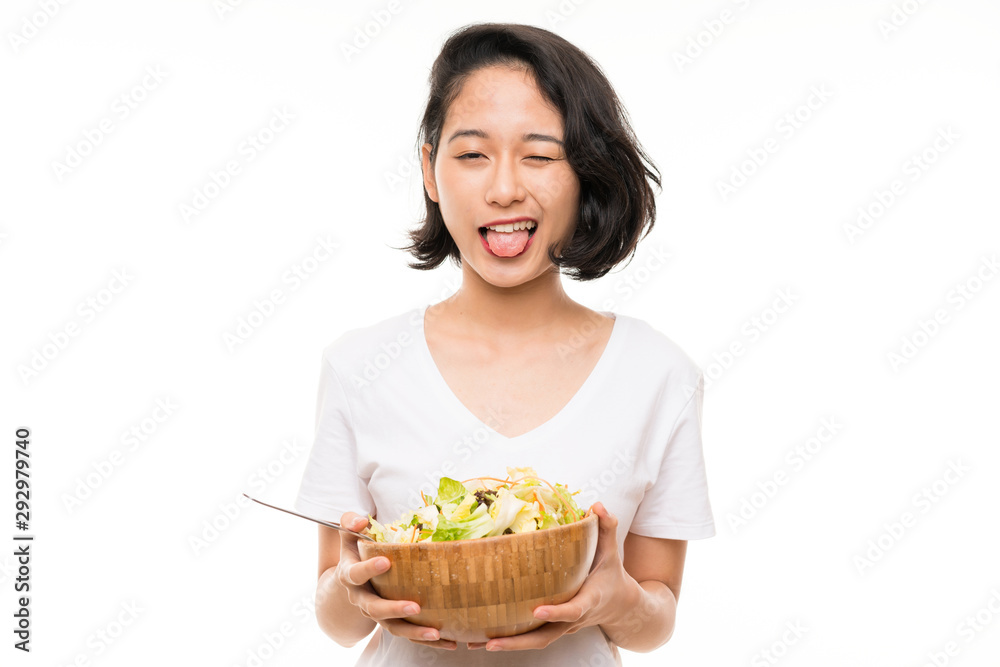 Asian young woman over isolated background with salad Asian young woman over isolated background with salad