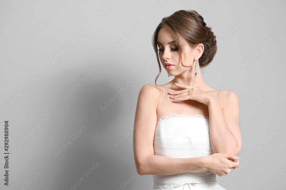 Portrait of beautiful young bride on grey background Portrait of beautiful young bride on grey background