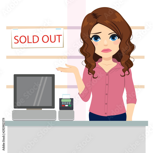 Sad young female clerk showing sold out banner on store empty shelves