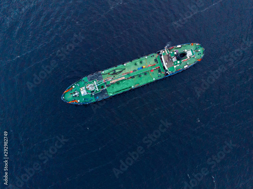Oil chemical tanker sails blue sea fog. Aerial top view