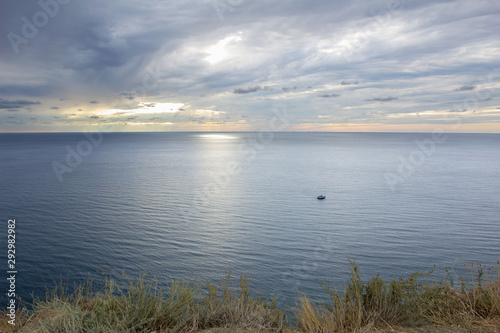 calm landscape sea merging on the horizon with cloudy sky