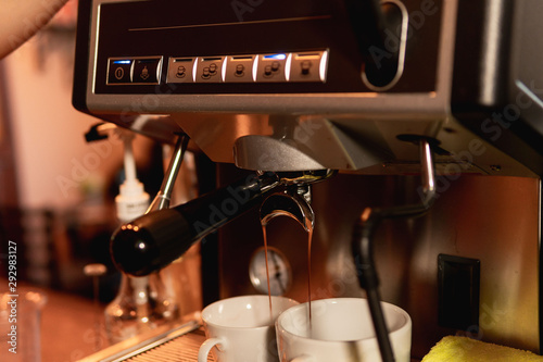 Barista in coffee shop preparing a cappuccino