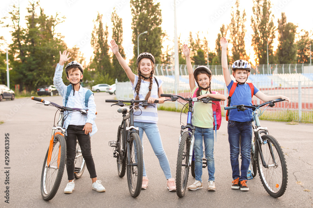 Obraz premium Cute children riding bicycles outdoors