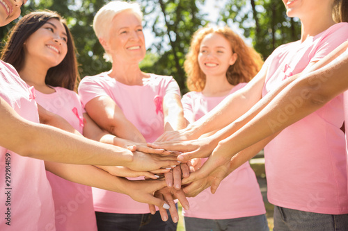 Diverse Volunteers In Pink Ribbon T-Shirts Holding Hands Outdoor