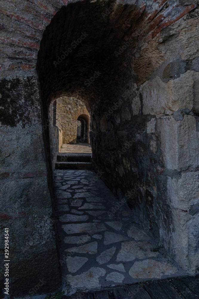 View through an arched passage in a thick rampart