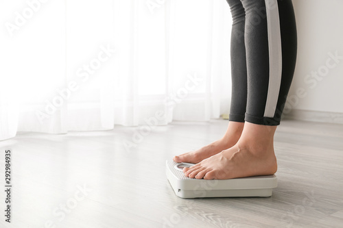 Woman standing on scales. Weight loss concept